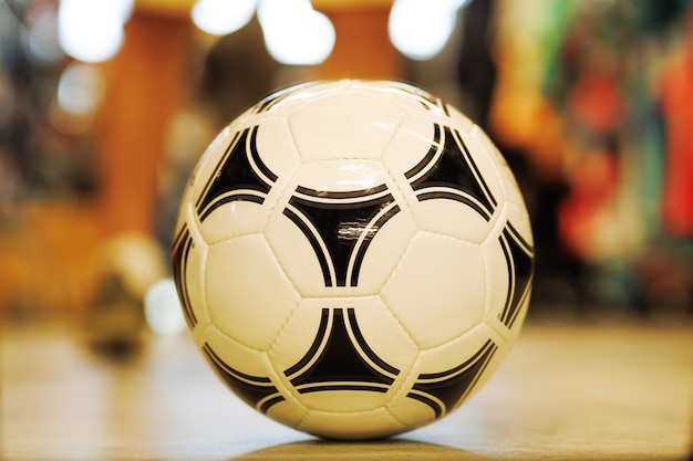 Soccer ball closeup on the floor on a multicolored background