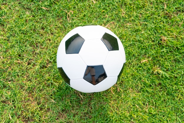 Soccer ball on the football field  background with copy space