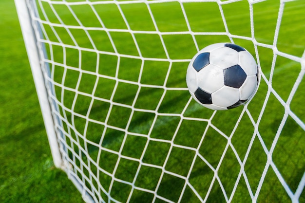 Soccer ball in goal, close-up view