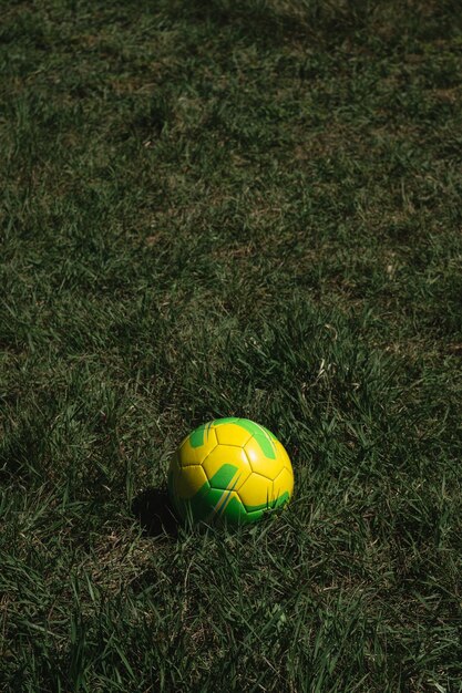 Soccer ball on the grass on the field football sports and\
recreation yellow and green leather ball