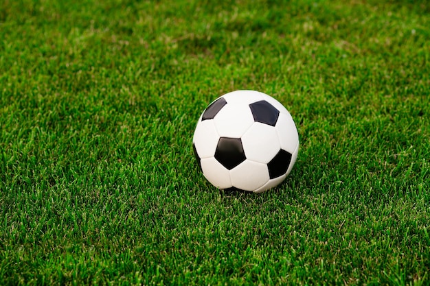 Soccer ball on a green grass closeup Concept football passion