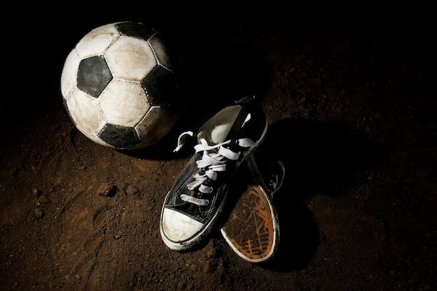 Soccer ball on ground on dark background