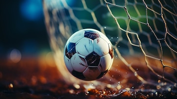 Soccer ball kicked into the goal net on the football field background. |  Premium AI-generated image