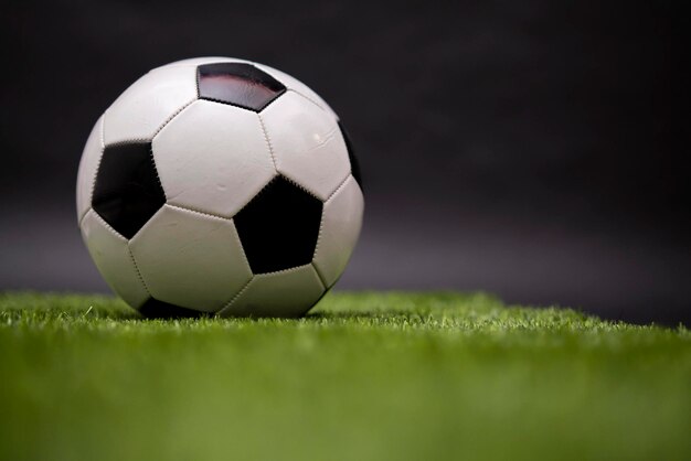 The soccer ball lies on the lawn football in the stadium\
football field sports competition football