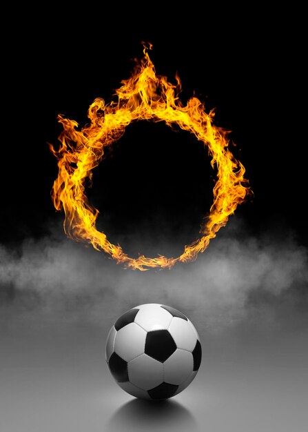 Soccer ball and ring of fire in black smoke background