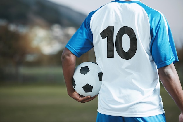 Soccer ball sports and man with uniform number on a field for exercise fitness and training outdoor Football club pitch and event or game with athlete person and mockup for sport competition