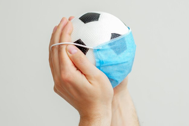 Soccer ball with a medical mask.