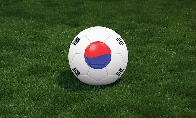 Футбольный мяч с цветами флага Южной Кореи на стадионе на фоне зеленых трав
