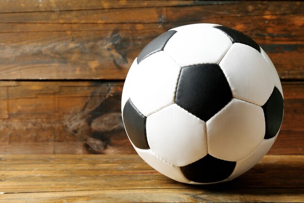 Soccer ball on wooden table