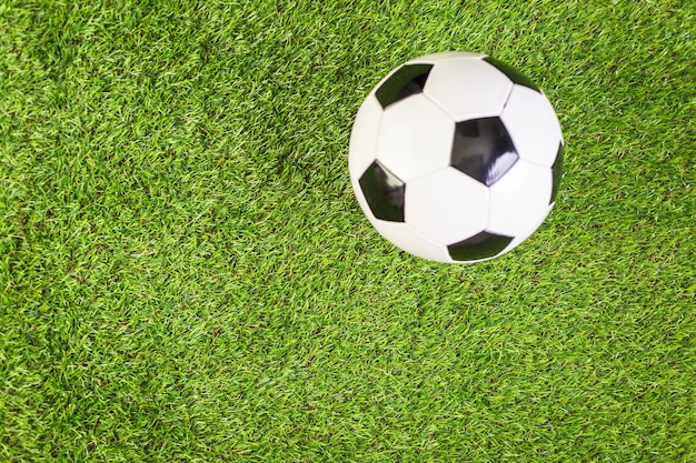 Soccer balls on a artificial turf as background.