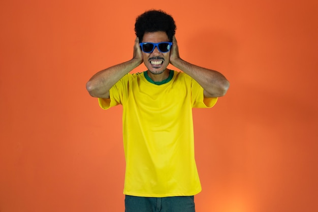 Soccer Brazilian Fan Celebrating Isolated on Orange Background