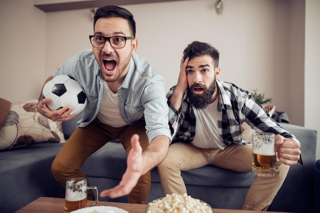 Soccer fans watching game in the room