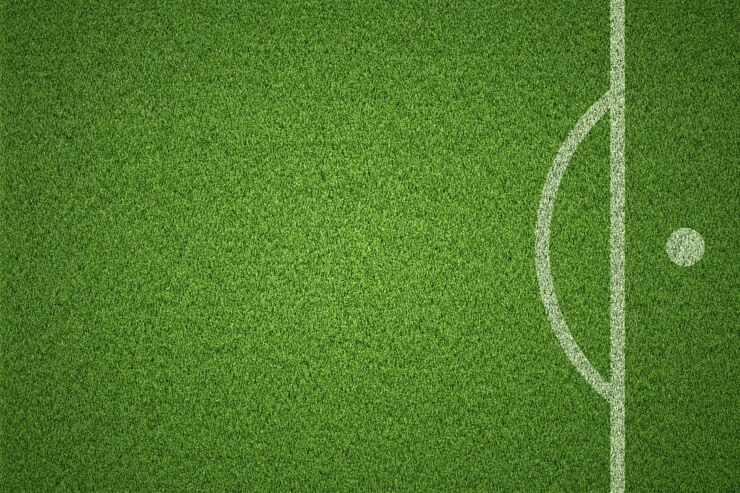 Photo soccer field or football field on green grass background