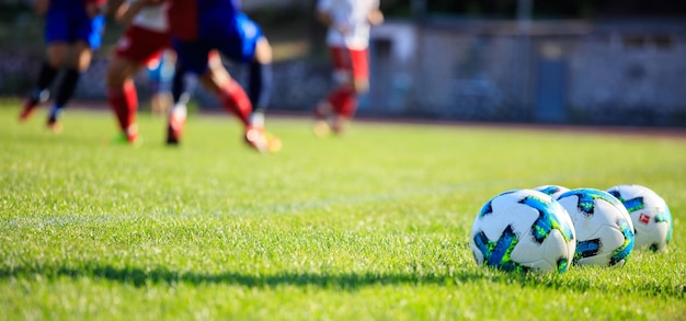 Soccer football balls on the soccer field