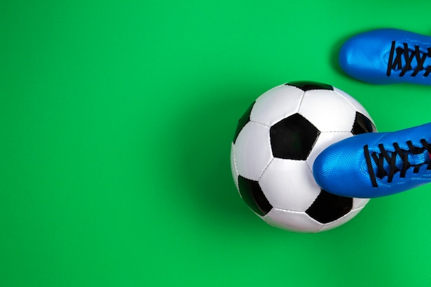 緑の背景にサッカーボールとサッカーのフットボール選手