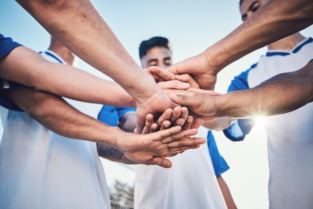 Soccer hands together and teamwork support and sports for training at stadium Collaboration group huddle and football players with motivation for exercise workout goal or success in competition