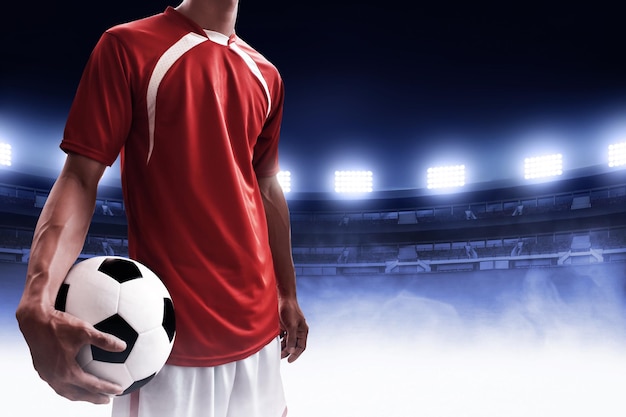 Soccer player holding soccer ball