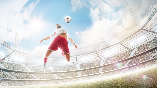 soccer player jumping to hit a soccer ball with his chest