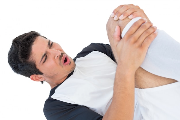 Soccer player lying down and shouting in pain