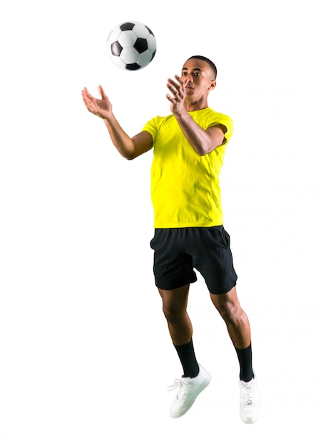 Soccer player man with dark skinned playing on isolated white background