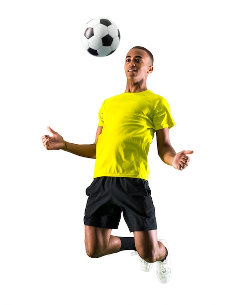 Soccer player man with dark skinned playing on isolated white background