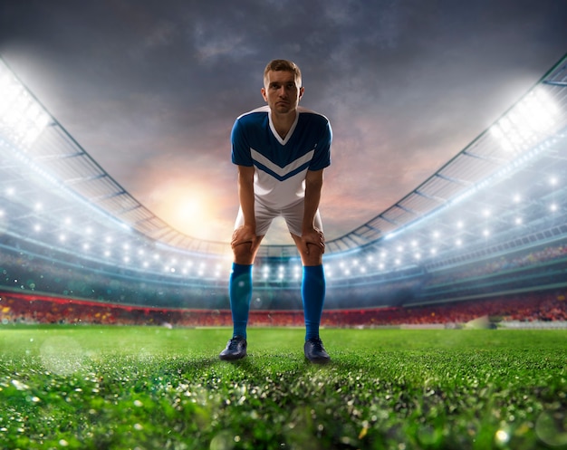 Soccer player ready to kick the soccerball at the illuminated stadium during the match