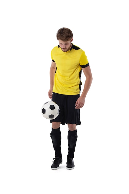 Soccer player with ball on white