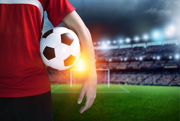 Soccer player with a soccer ball at the stadium