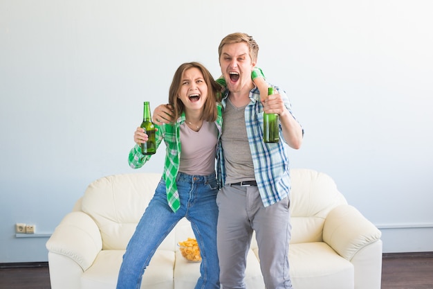 Soccer world cup concept - Young friends drink beer and cheering for football