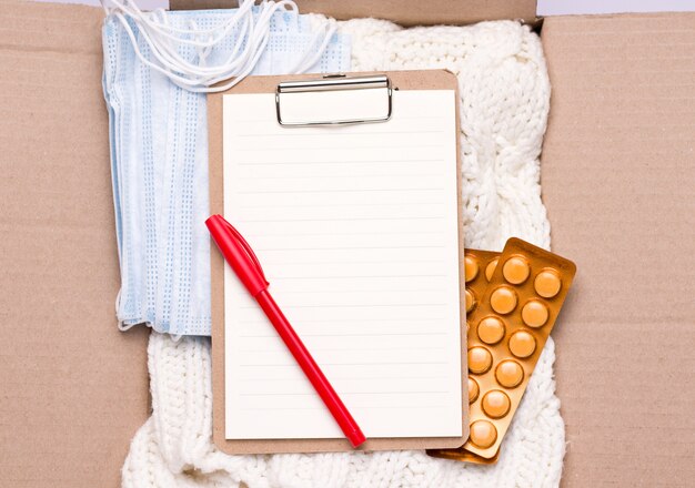 Photo social assistance concept. in a cardboard box is an empty form, things, medicines