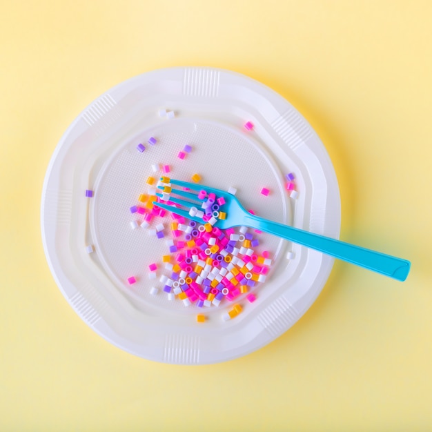 Social content. Plastic food in disposable dishes on a yellow background.