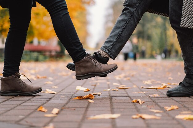 Photo social distancing greet with legs bumps for preventing corona virus spread