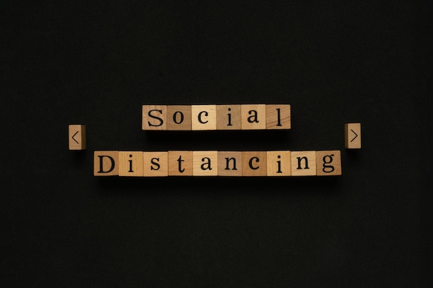 social distancing text on wooden block.