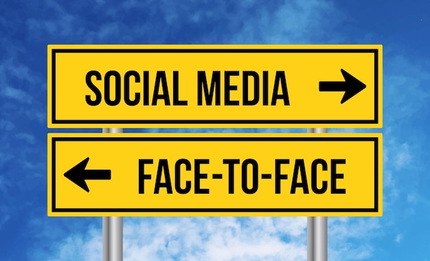 Social media or face to face road sign on cloudy sky background