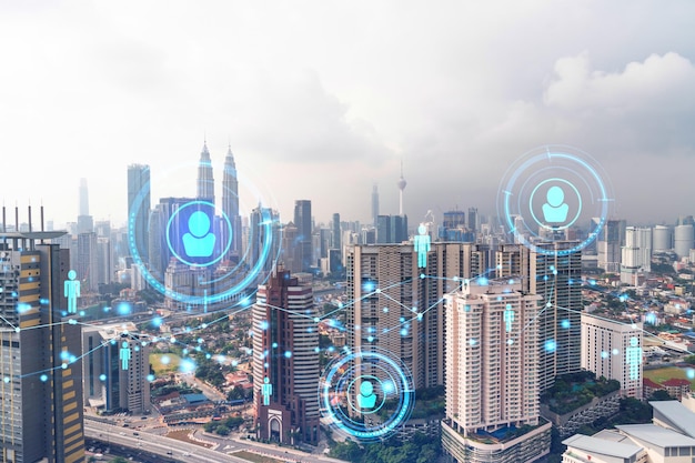 Social media icons hologram over panorama city view of Kuala Lumpur Malaysia Asia The concept of people networking connections and career opportunities Double exposure