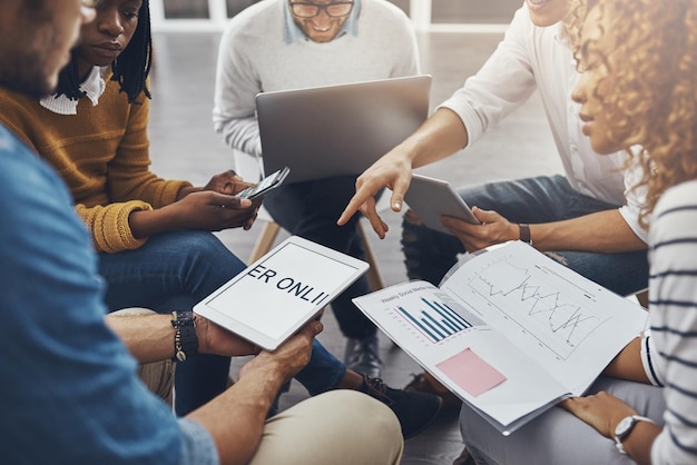 Social media is the key to success High angle shot of unrecognizable colleagues having a meeting in the office