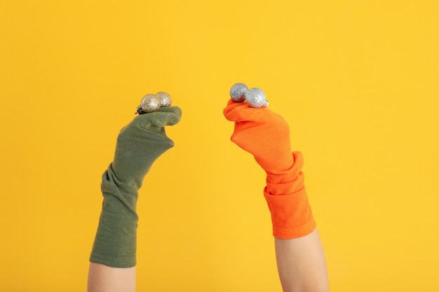 Sock puppets with baubles on yellow background