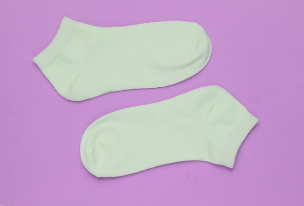 Socks on pink background. Minimalism fashion concept. Pastel color trend.