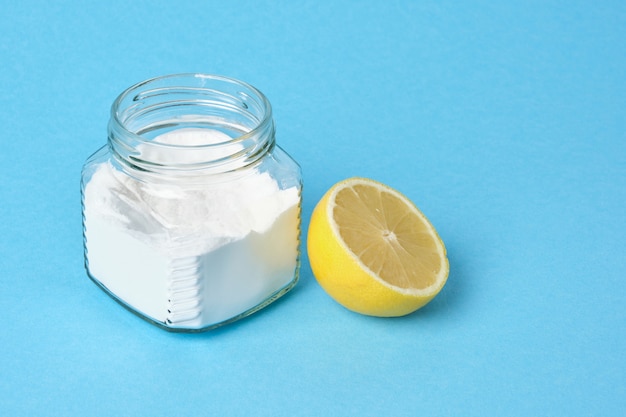 soda in jars and lemon on blue background