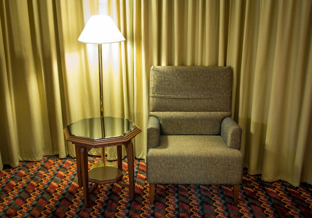 Sofa and lamp with table in the bedroom at night time