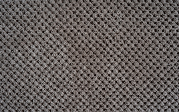 sofa upholstery closeup texture of rough dense ribbed fabric beige background
