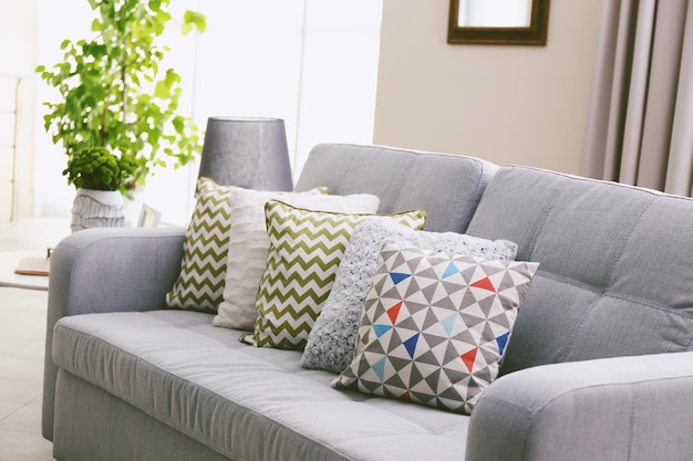 Sofa with colorful pillows in room