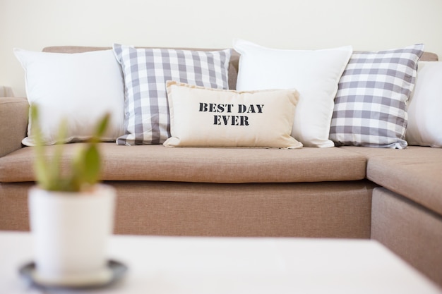 Sofa with many modern pillows in living room