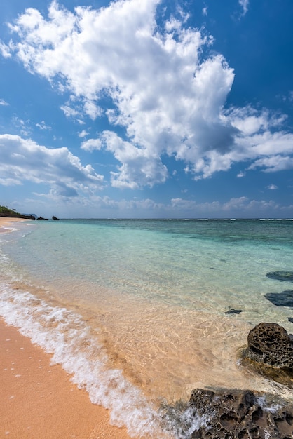 Soft aqua blue sea wave over clear sands and amazing rocks on a\
beach paradise