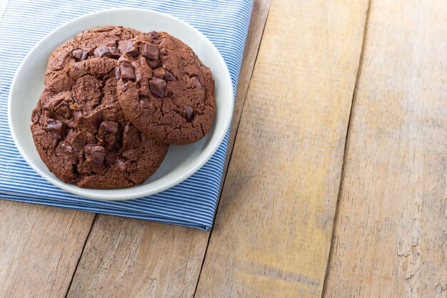 Soft baked chocolate cookies in white plate, close up picture