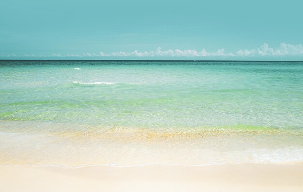 Soft blue ocean wave on sandy beach ocean blue background