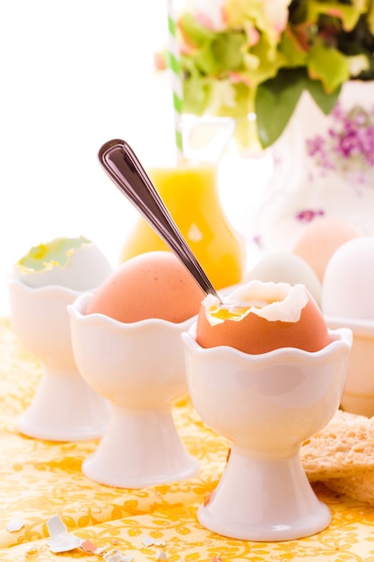 Soft boiled egg in egg cup and served with toast fingers.