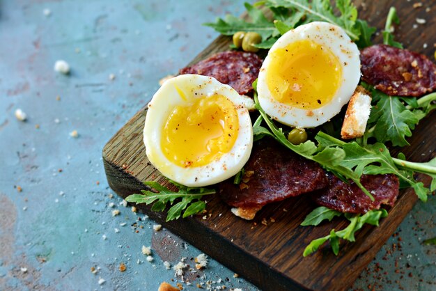 Soft-boiled eggs for Breakfast with chorizo sausage