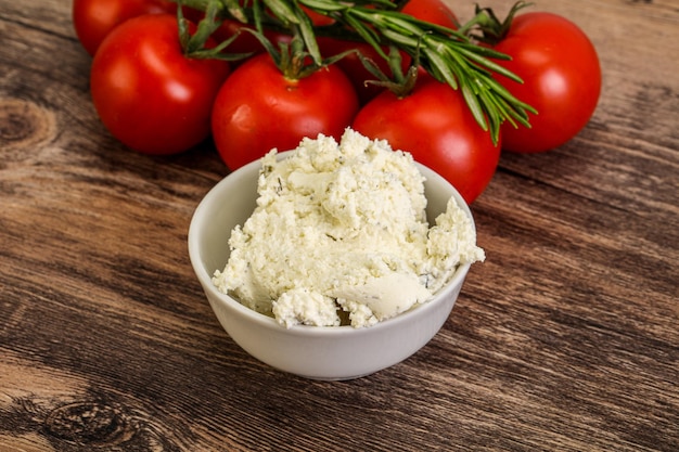 Soft cream cheese with herbs in the bowl