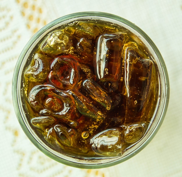 soft drink in a glass with ice cubes